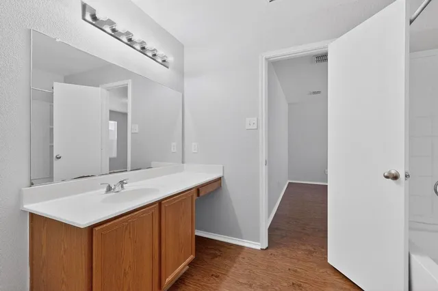a utility room with a sink and a mirror