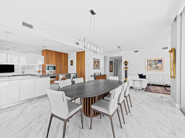 a kitchen with stainless steel appliances wooden floor and furniture