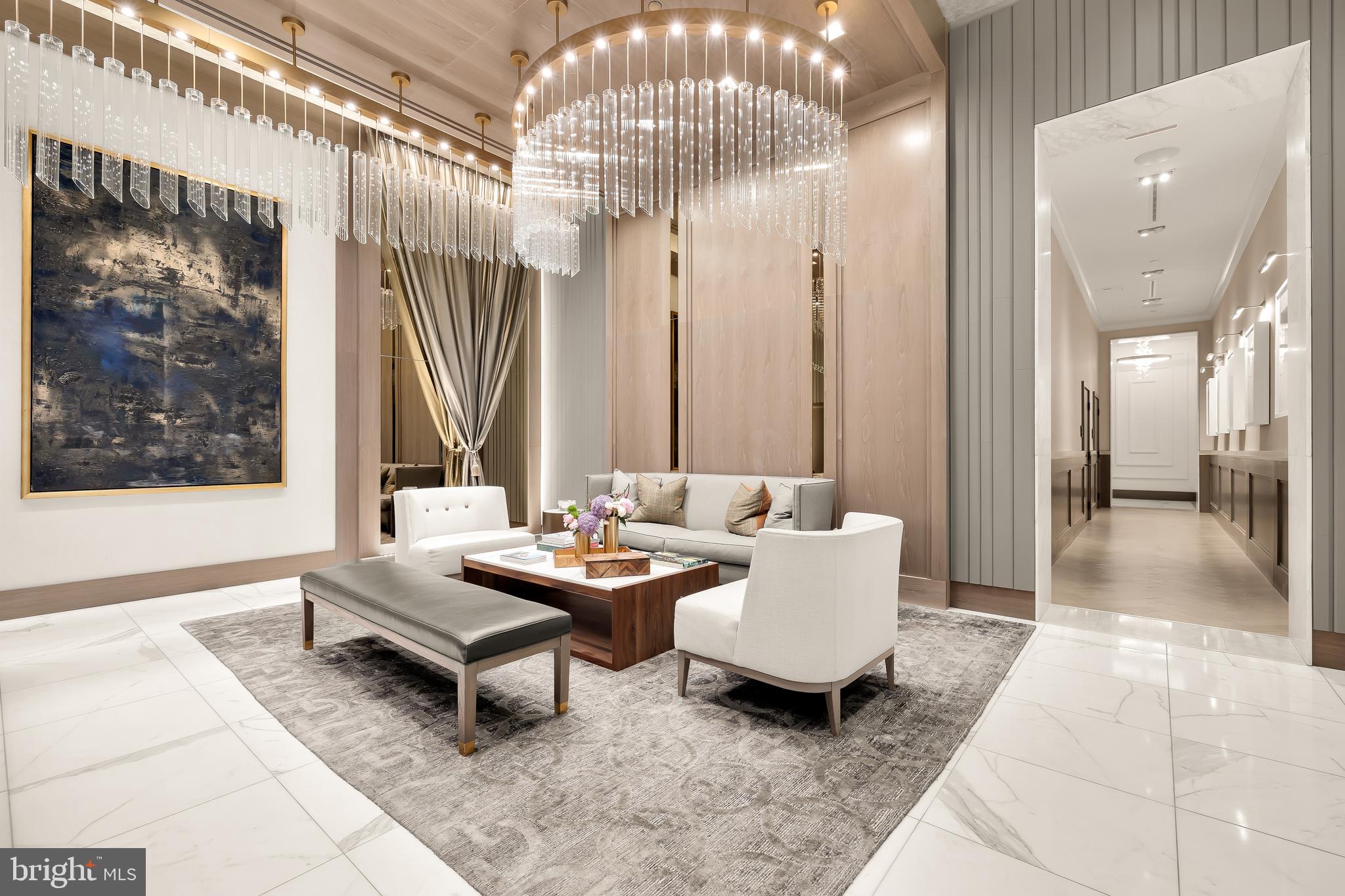 8551 Connecticut Avenue, Unit 411 Chevy Chase, MD 20815 - Photo 4 of 25 a living room with patio furniture and a chandelier