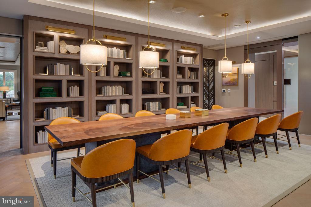 8551 Connecticut Avenue, Unit 411 Chevy Chase, MD 20815 - Photo 7 of 25 a dining room with a table chairs and a book shelf