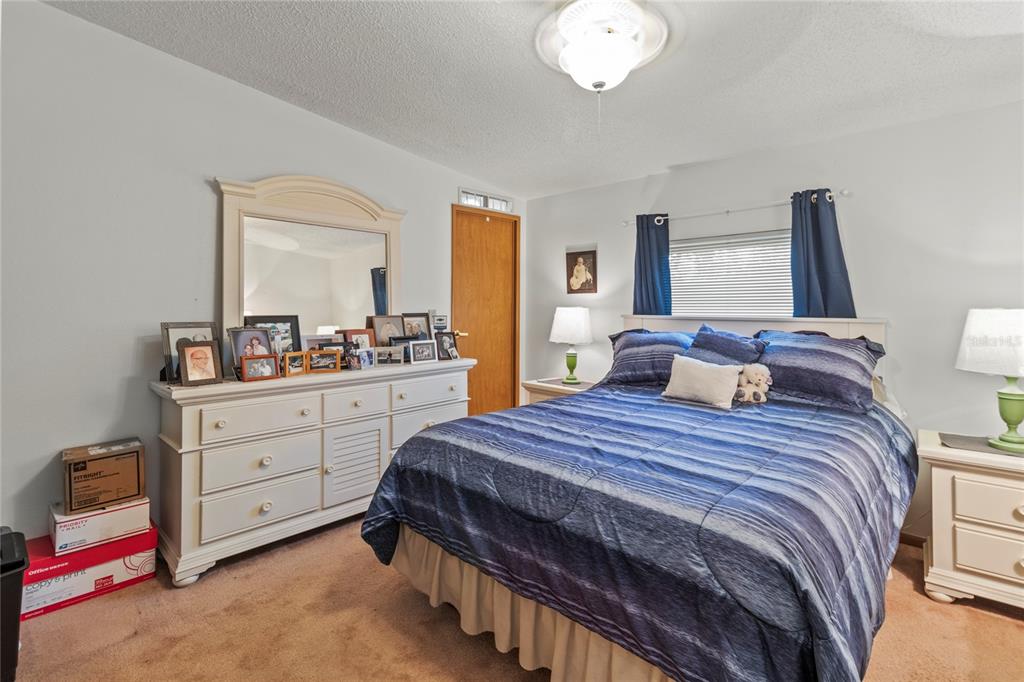 83 Eagle Circle Ellenton, FL 34222 - Photo 30 of 60 a bedroom with a bed and a dresser