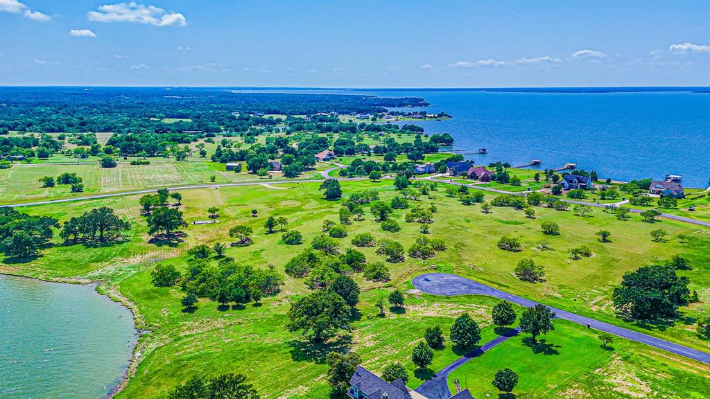 L77 R Moonlight Bay Court Streetman, TX 75859 - Photo 13 of 30 a view of a large building with a yard