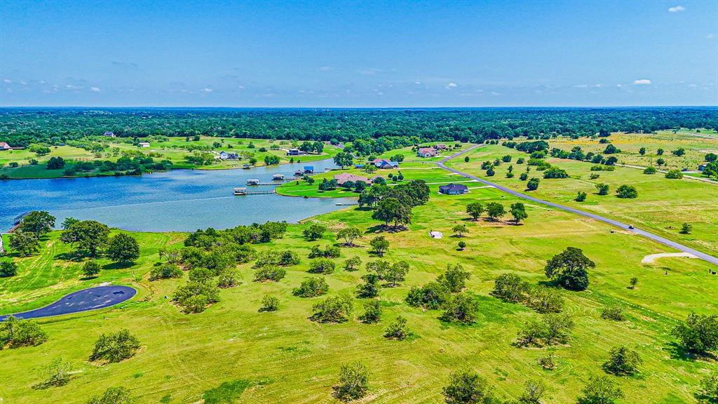 L77 R Moonlight Bay Court Streetman, TX 75859 - Photo 19 of 30 a view of a garden with a building in the background