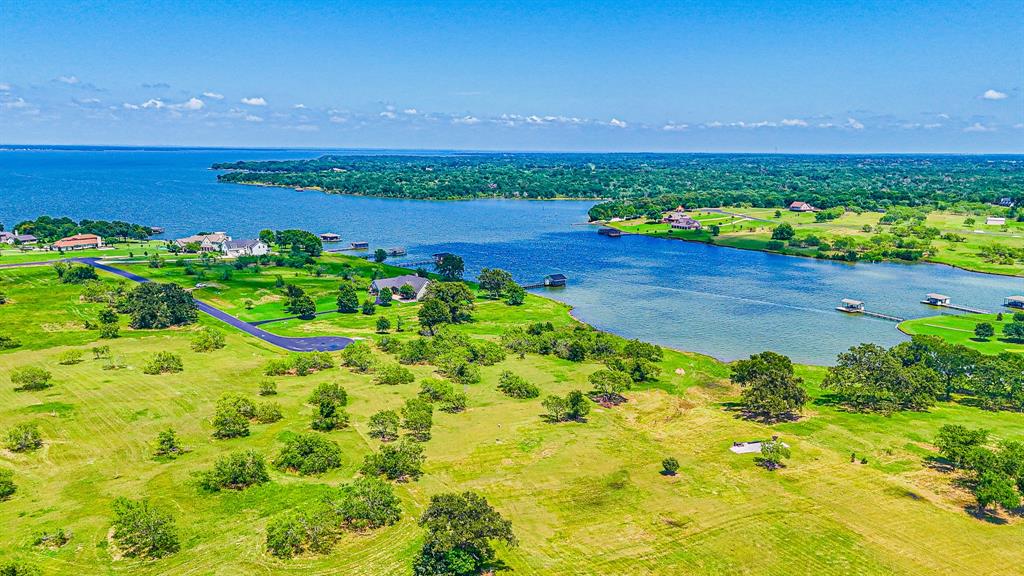 L77 R Moonlight Bay Court Streetman, TX 75859 - Photo 23 of 30 a view of a pathway with a garden