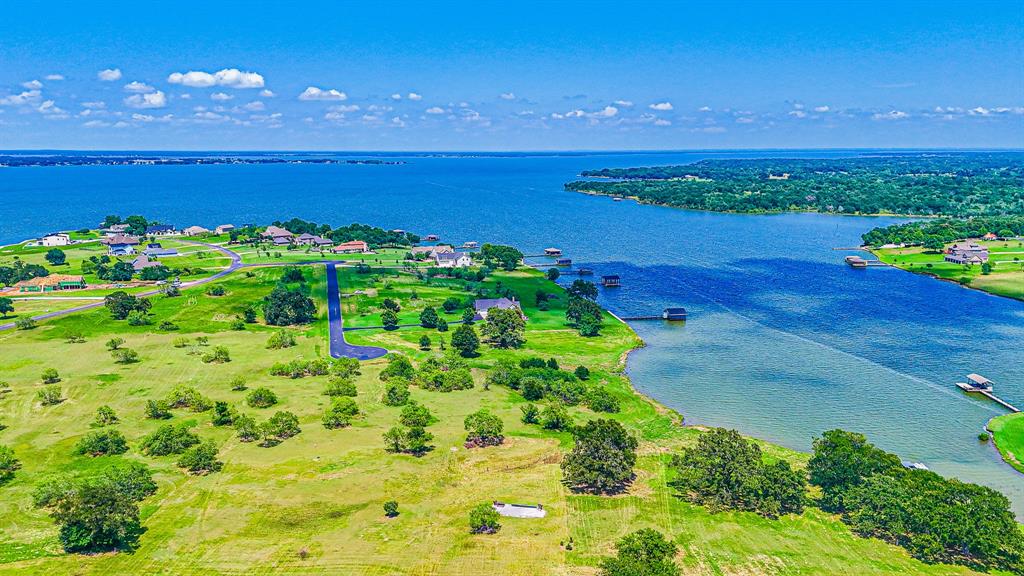 L77 R Moonlight Bay Court Streetman, TX 75859 - Photo 26 of 30 a view of a lake with a city