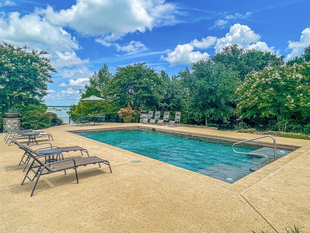 L77 R Moonlight Bay Court Streetman, TX 75859 - Photo 27 of 30 a view of a swimming pool with a lounge chairs