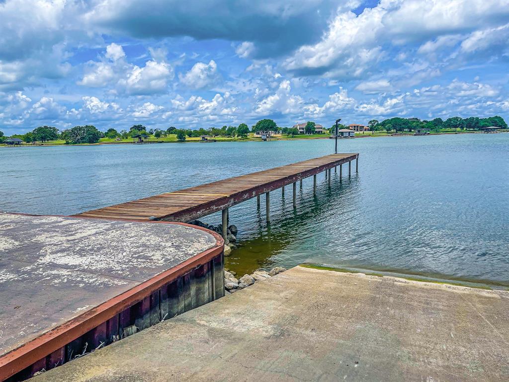 L77 R Moonlight Bay Court Streetman, TX 75859 - Photo 28 of 30 a view of a lake with a mountain in the background