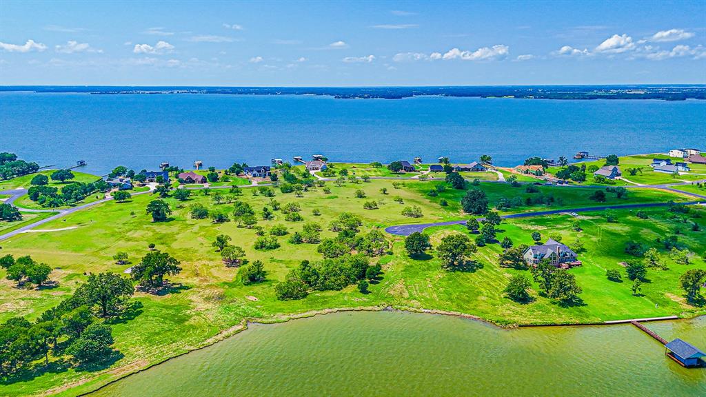 L77 R Moonlight Bay Court Streetman, TX 75859 - Photo 9 of 30 a view of a lake with a big yard