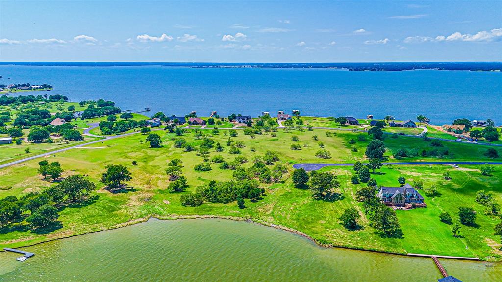 L77 R Moonlight Bay Court Streetman, TX 75859 - Photo 10 of 30 a view of a houses with a yard and lake view