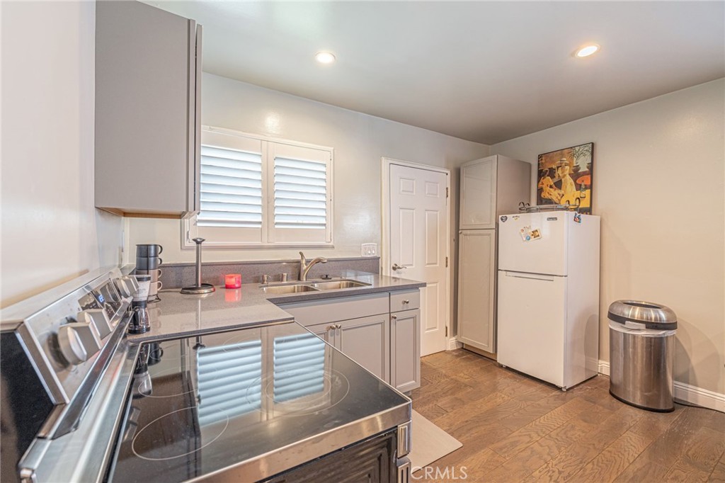 2548 East Washington Street Carson, CA 90810 - Photo 12 of 44 a kitchen with a sink stove and refrigerator