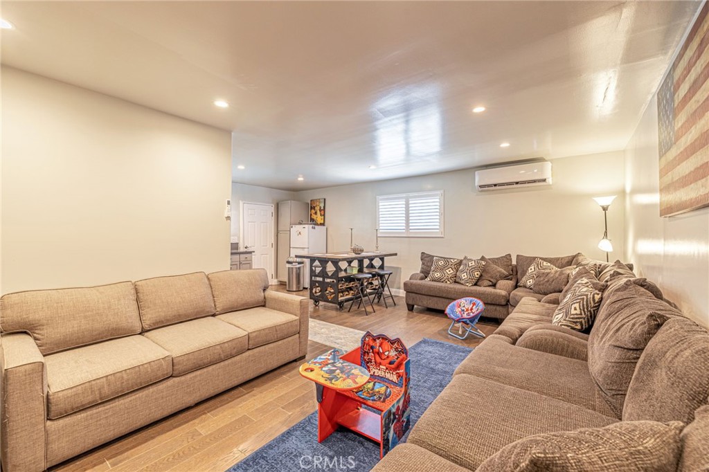 2548 East Washington Street Carson, CA 90810 - Photo 16 of 44 a living room with furniture white walls and a couch