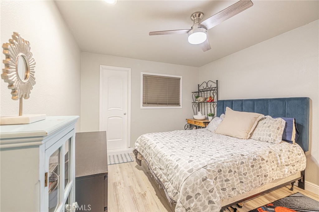 2548 East Washington Street Carson, CA 90810 - Photo 20 of 44 a bedroom with a large bed and a chandelier