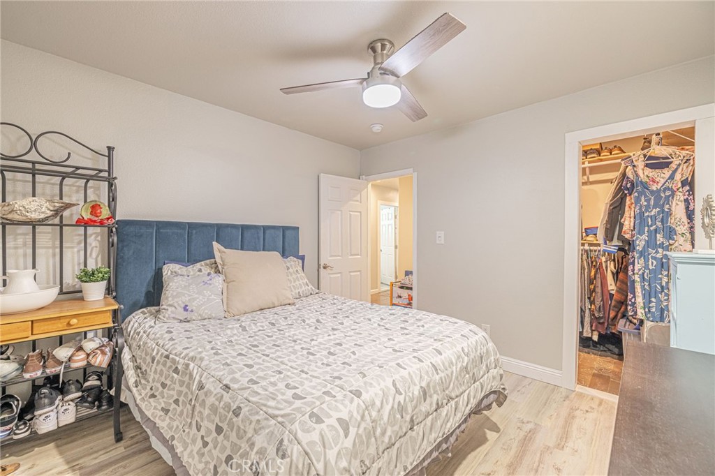 2548 East Washington Street Carson, CA 90810 - Photo 21 of 44 a bedroom with a bed and a chandelier