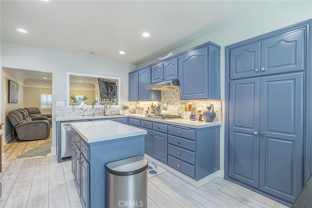 2548 East Washington Street Carson, CA 90810 - Photo 25 of 44 a kitchen with a refrigerator a sink and wooden cabinets