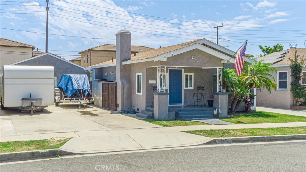 2548 East Washington Street Carson, CA 90810 - Photo 6 of 44 a view of a house with a small yard and potted plants