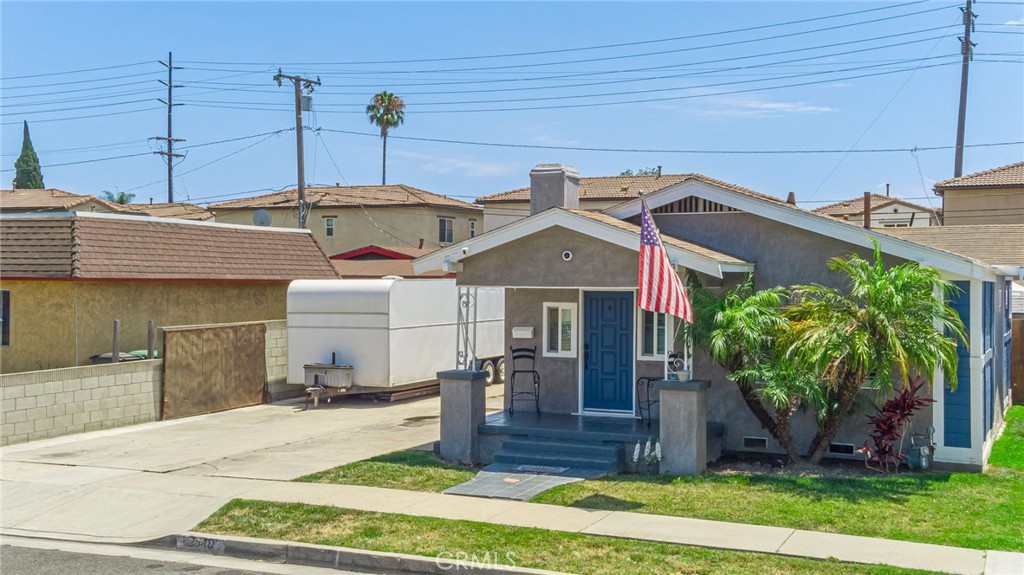 2548 East Washington Street Carson, CA 90810 - Photo 10 of 44 a front view of a house with garden