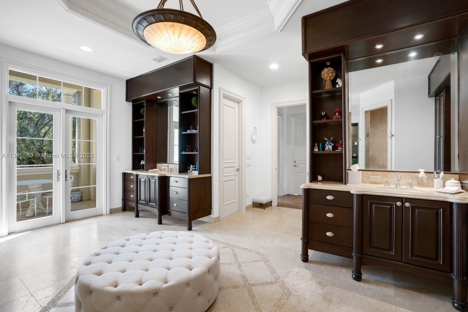5001 Pine Drive Miami, FL 33143 - Photo 15 of 32 a spacious bathroom with a sink a large mirror and a bathtub