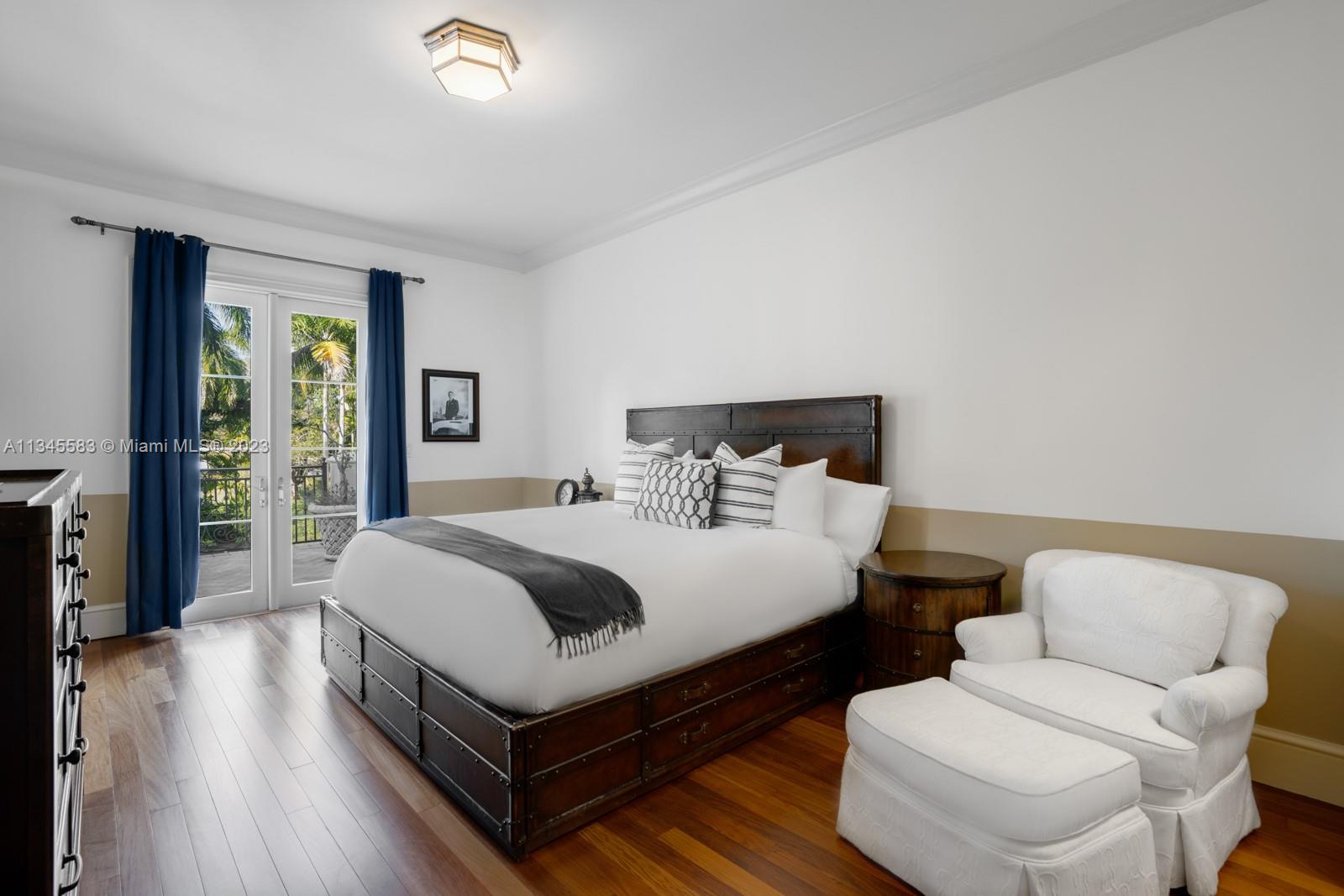 5001 Pine Drive Miami, FL 33143 - Photo 16 of 32 a bedroom with a bed and wooden floor