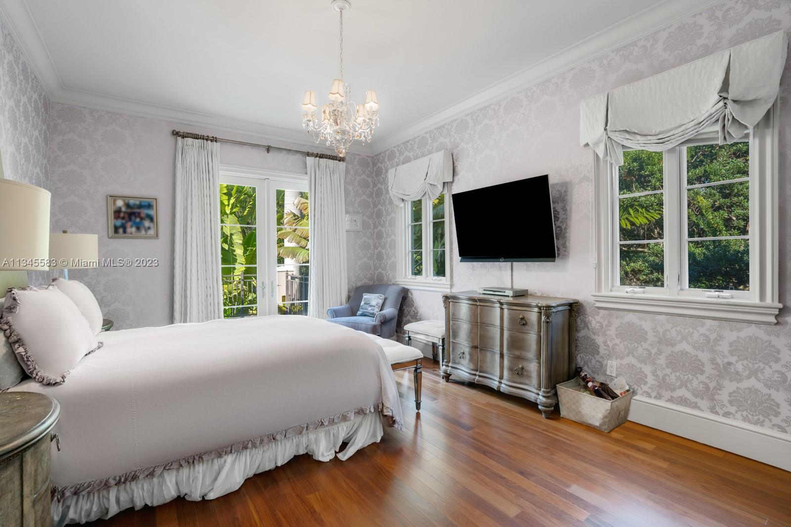 5001 Pine Drive Miami, FL 33143 - Photo 19 of 32 a bedroom with a bed and a flat screen tv