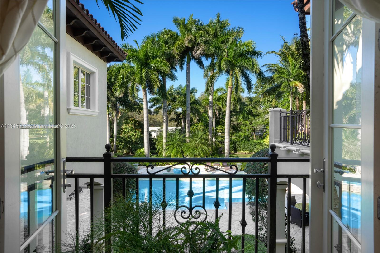 5001 Pine Drive Miami, FL 33143 - Photo 21 of 32 a view of a porch with a floor to ceiling window and wooden fence