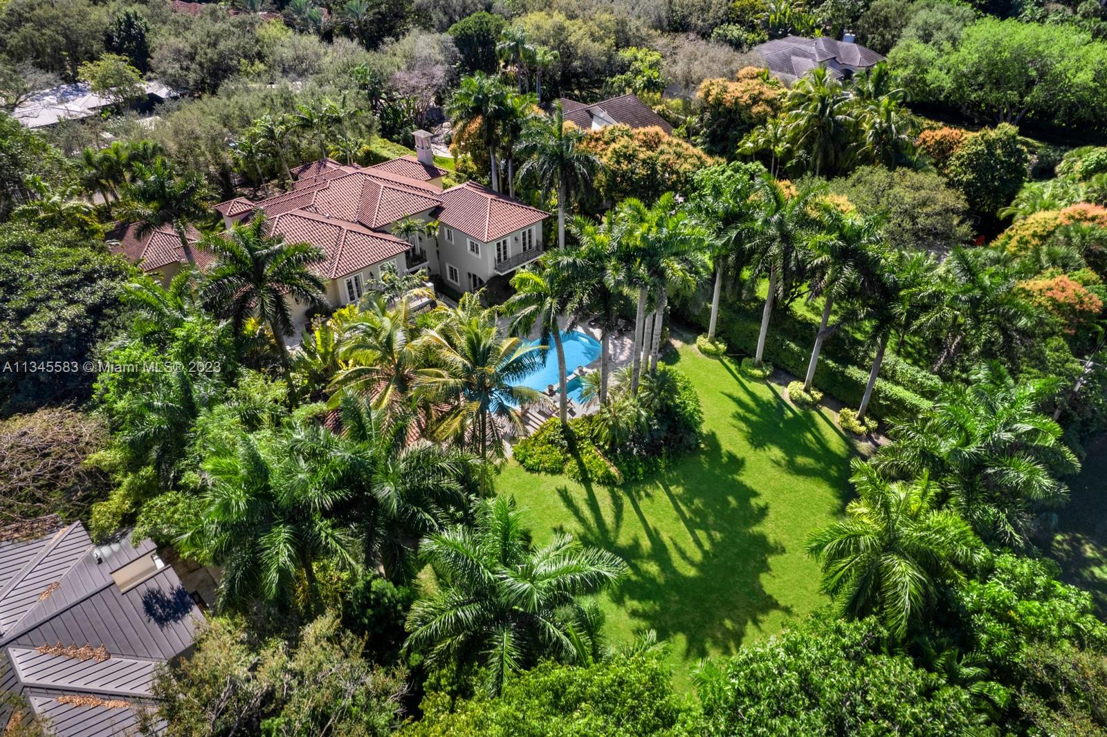 5001 Pine Drive Miami, FL 33143 - Photo 28 of 32 an aerial view of a house with a yard and lake view