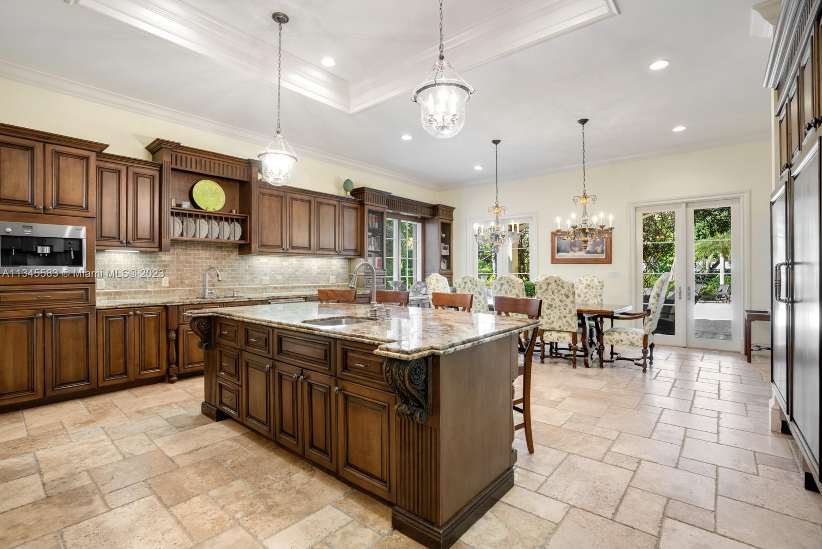 5001 Pine Drive Miami, FL 33143 - Photo 7 of 32 a kitchen with stainless steel appliances granite countertop a stove a sink a oven a dining table and chairs