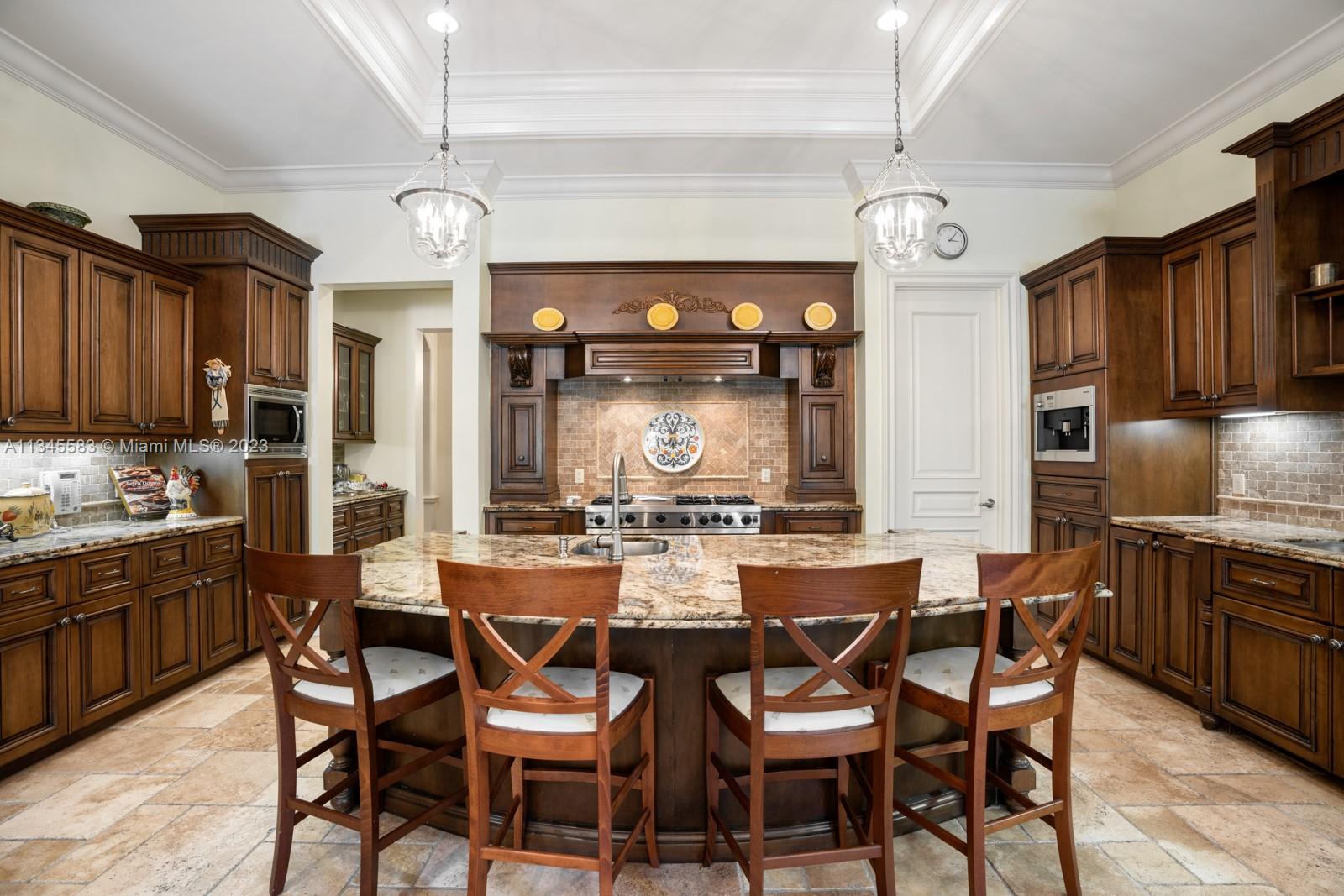 5001 Pine Drive Miami, FL 33143 - Photo 8 of 32 a kitchen with a dining table and chairs
