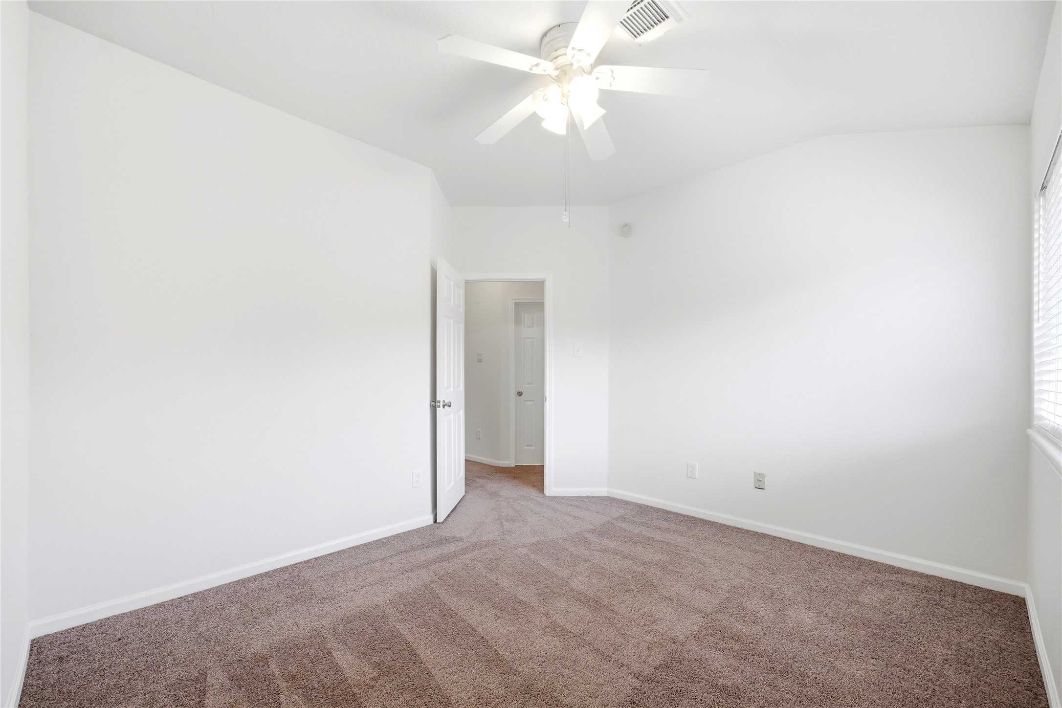 5411 Gate Canyon Court Spring, TX 77373 - Photo 27 of 33 an empty room with a ceiling fan and a window