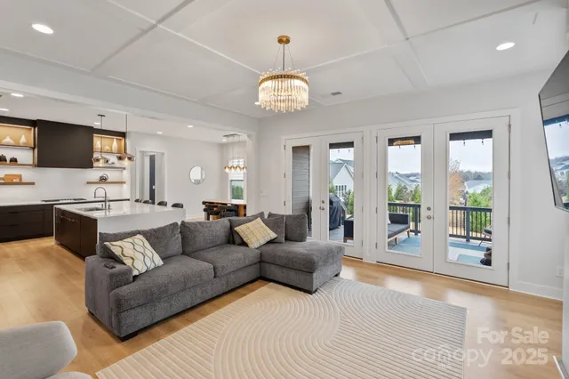 a living room with furniture a flat screen tv and a large window