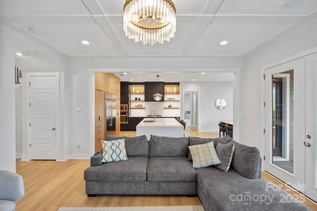 a living room with furniture and a chandelier