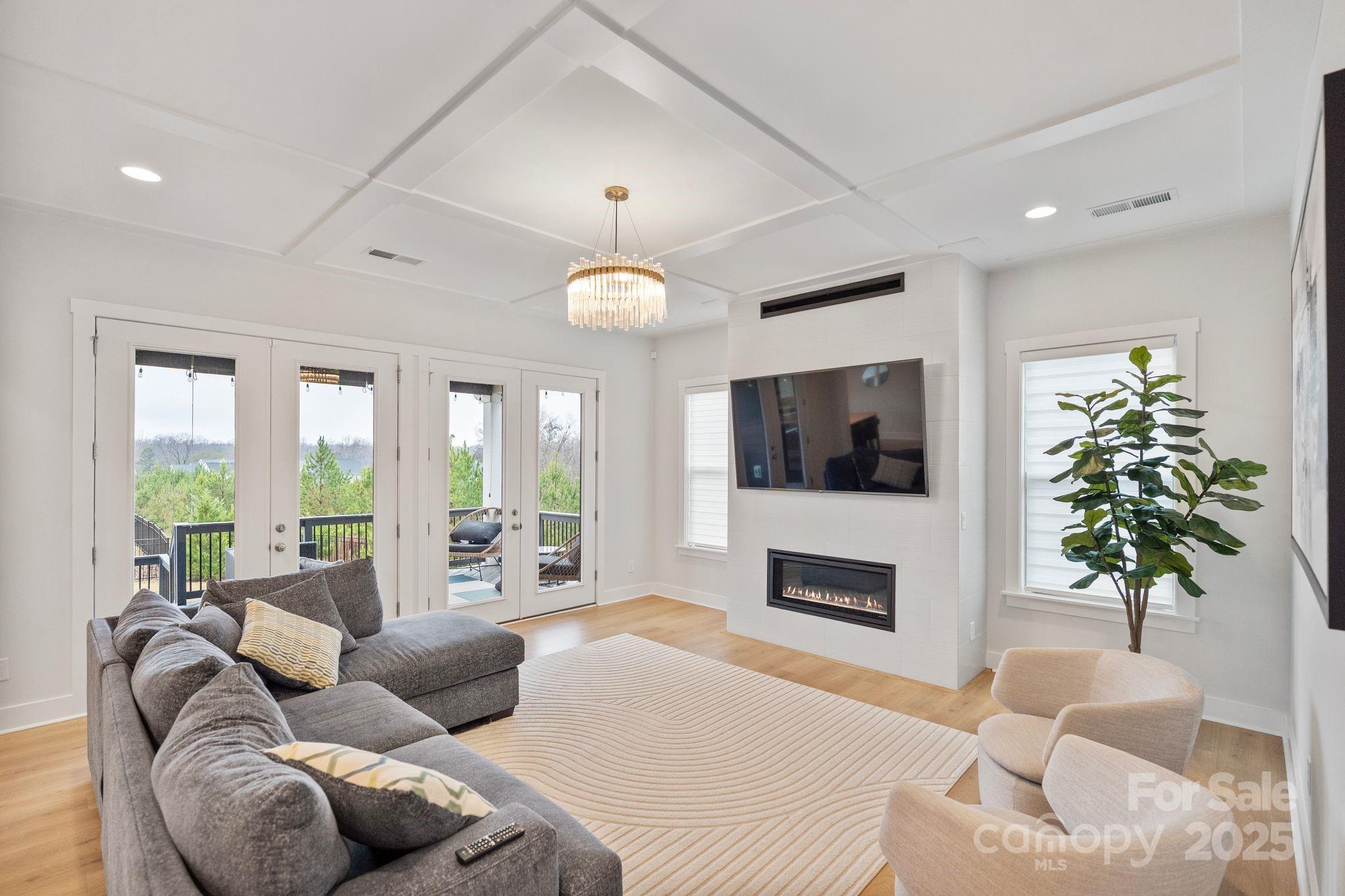 2075 Masons Bend Drive Fort Mill, SC 29708 - Photo 15 of 47 a living room with furniture a flat screen tv and a fireplace