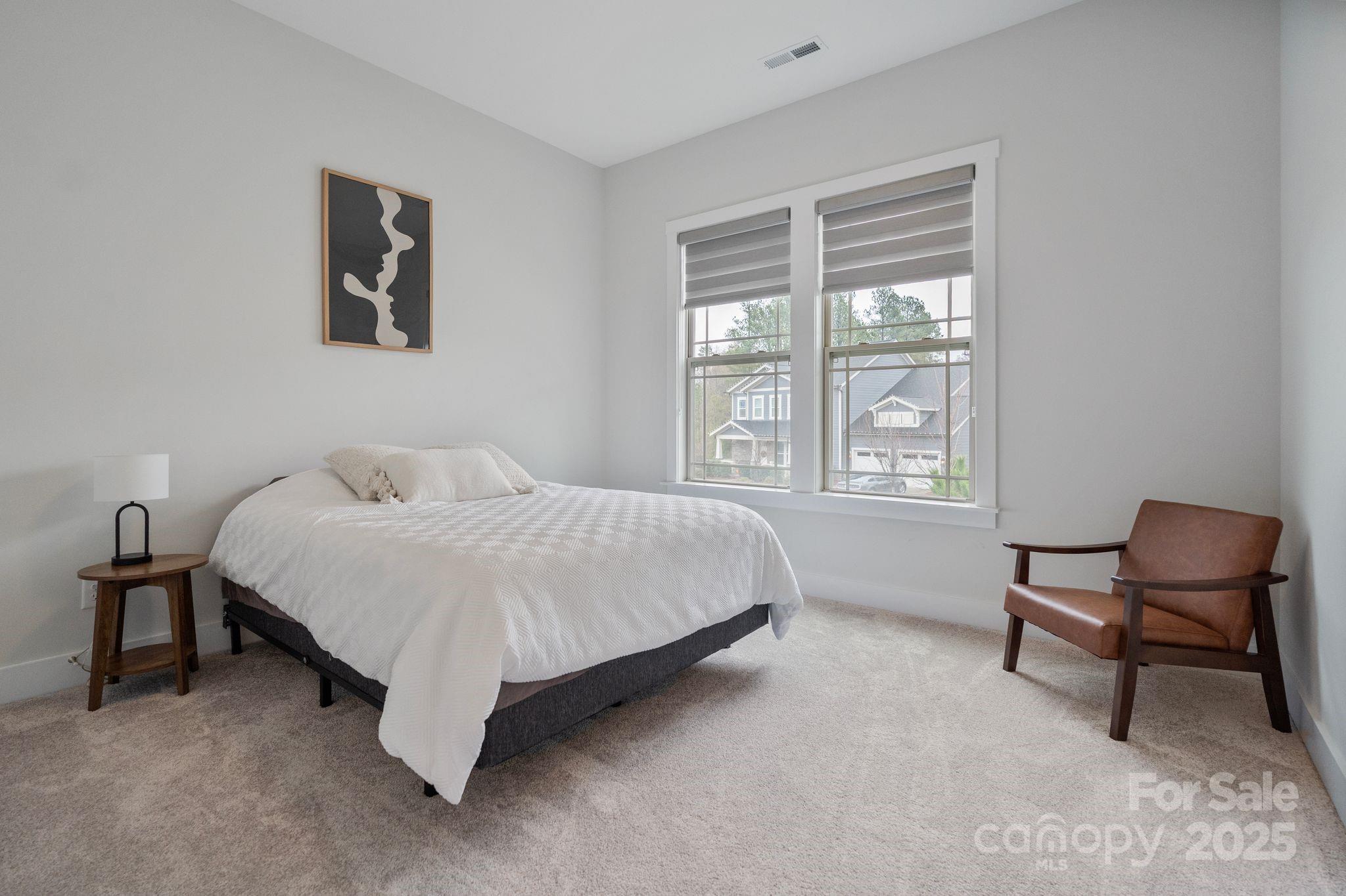 2075 Masons Bend Drive Fort Mill, SC 29708 - Photo 16 of 47 a bedroom with a bed chair and painting on the wall