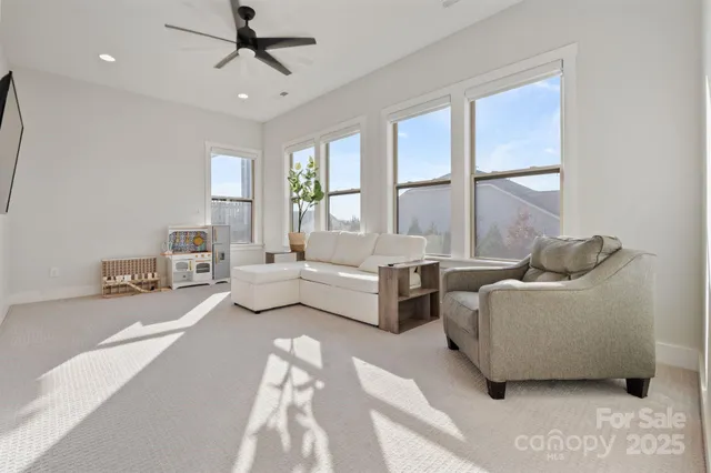 a spacious bedroom with a bed and large windows