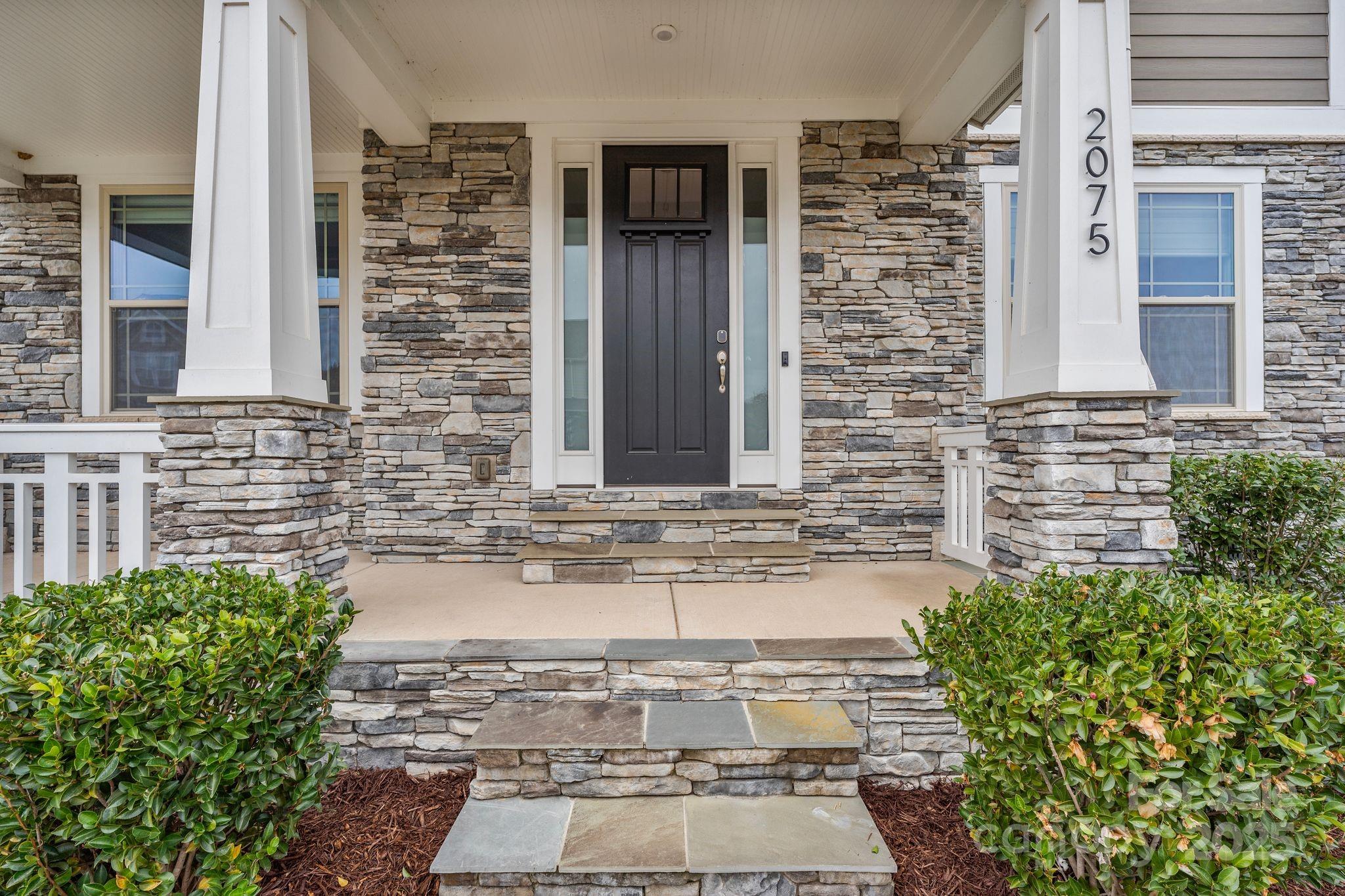 2075 Masons Bend Drive Fort Mill, SC 29708 - Photo 2 of 47 front view of a brick house with potted plants