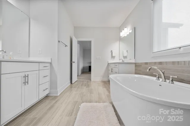 a view of a kitchen with white cabinets