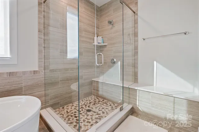 a bathroom with a tub and a shower
