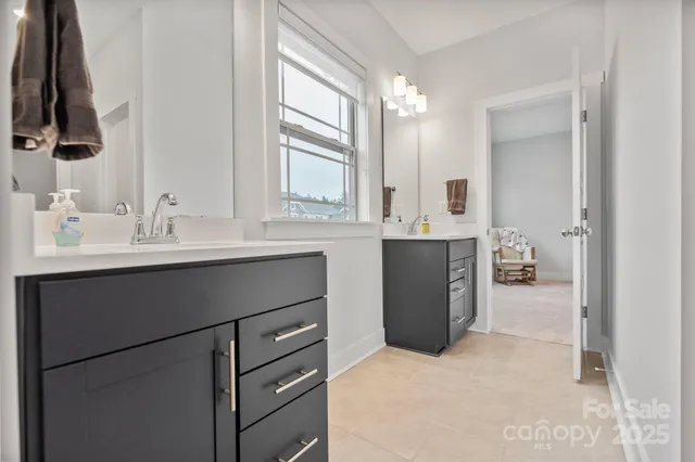 a bathroom with a double vanity sink and mirror