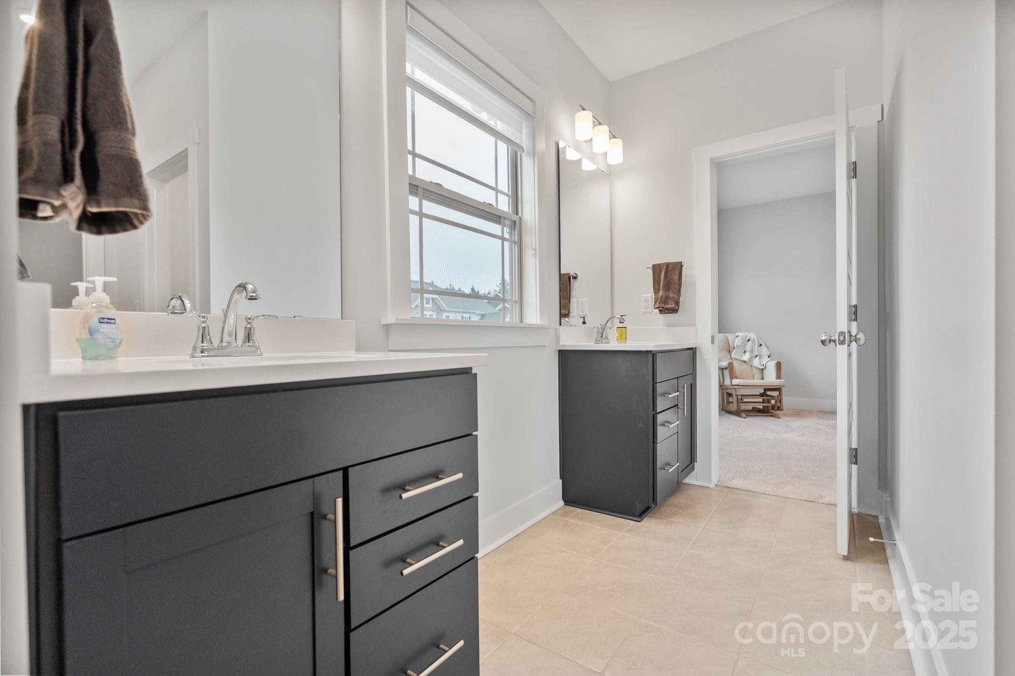 2075 Masons Bend Drive Fort Mill, SC 29708 - Photo 32 of 47 a bathroom with a double vanity sink and mirror