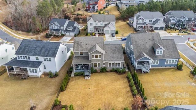 an aerial view of residential houses with outdoor space and swimming pool