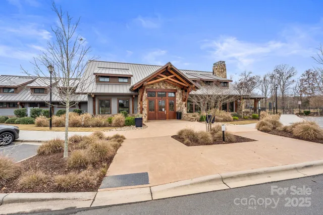 a front view of a building with large trees