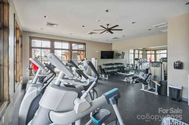 a view of a livingroom with furniture and a ceiling fan