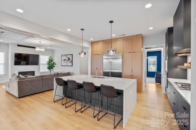 a large kitchen with cabinets table and chairs