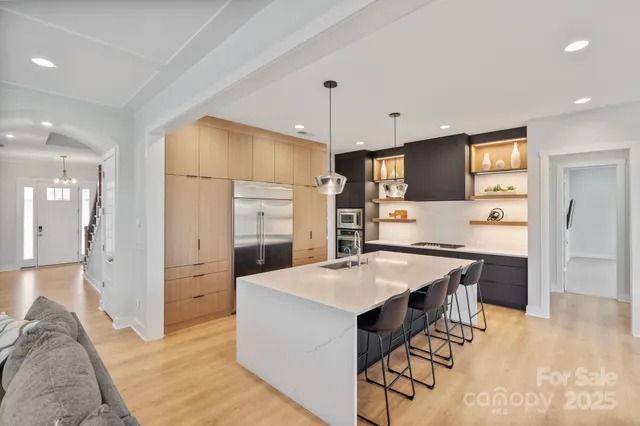 a large kitchen with a large counter top appliances and cabinets
