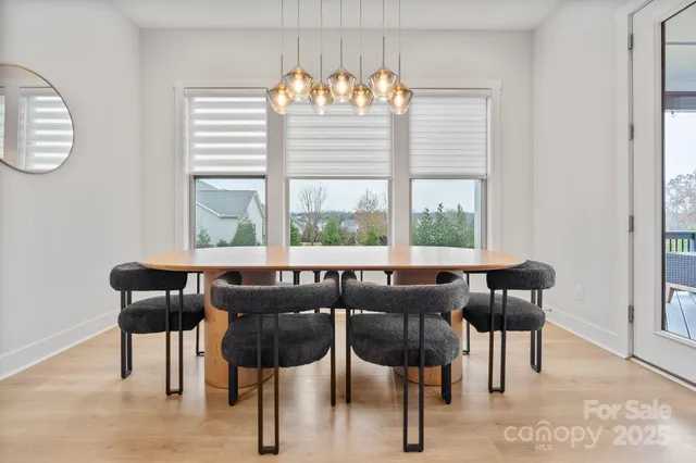 a view of a dining room with furniture and windows