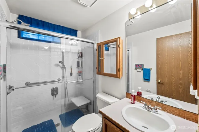 a bathroom with a toilet and a shower