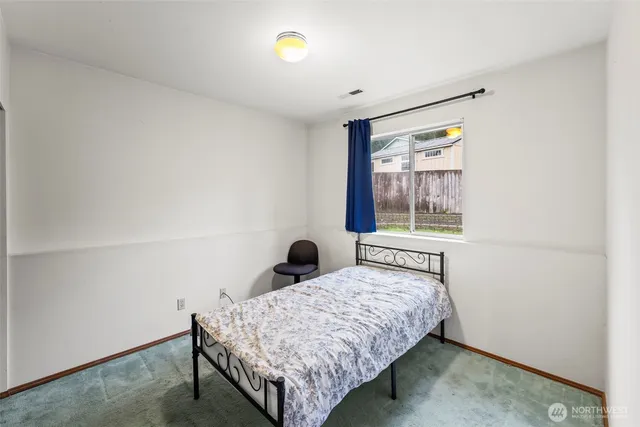 a bedroom with a bed and a television in it