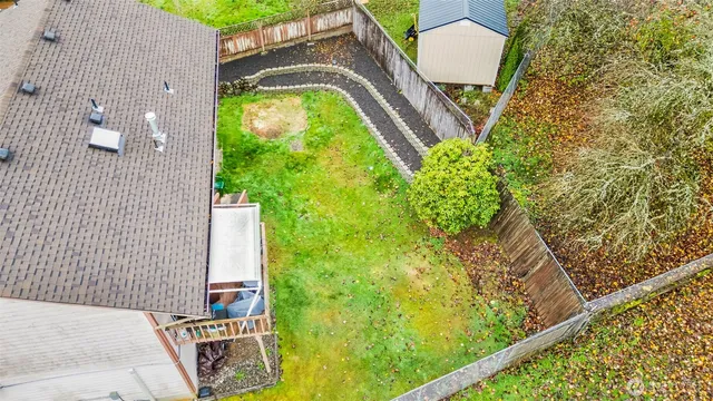 an aerial view of residential houses with yard