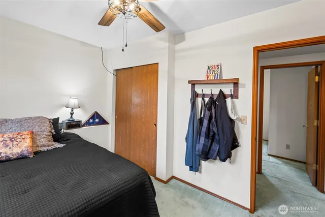 a view of a backyard with table and chairs a fire pit and wooden fence
