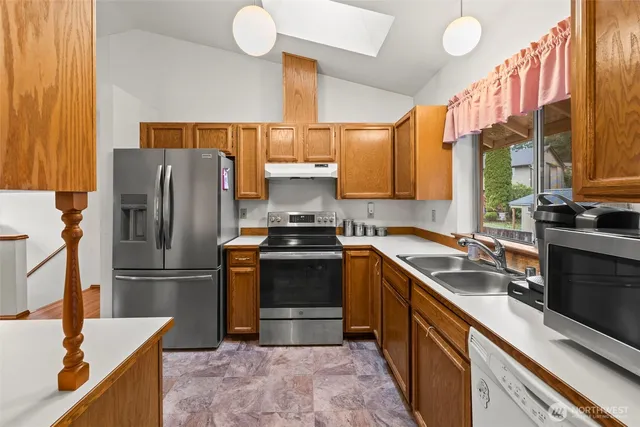 a dining room with furniture a chandelier and wooden floor