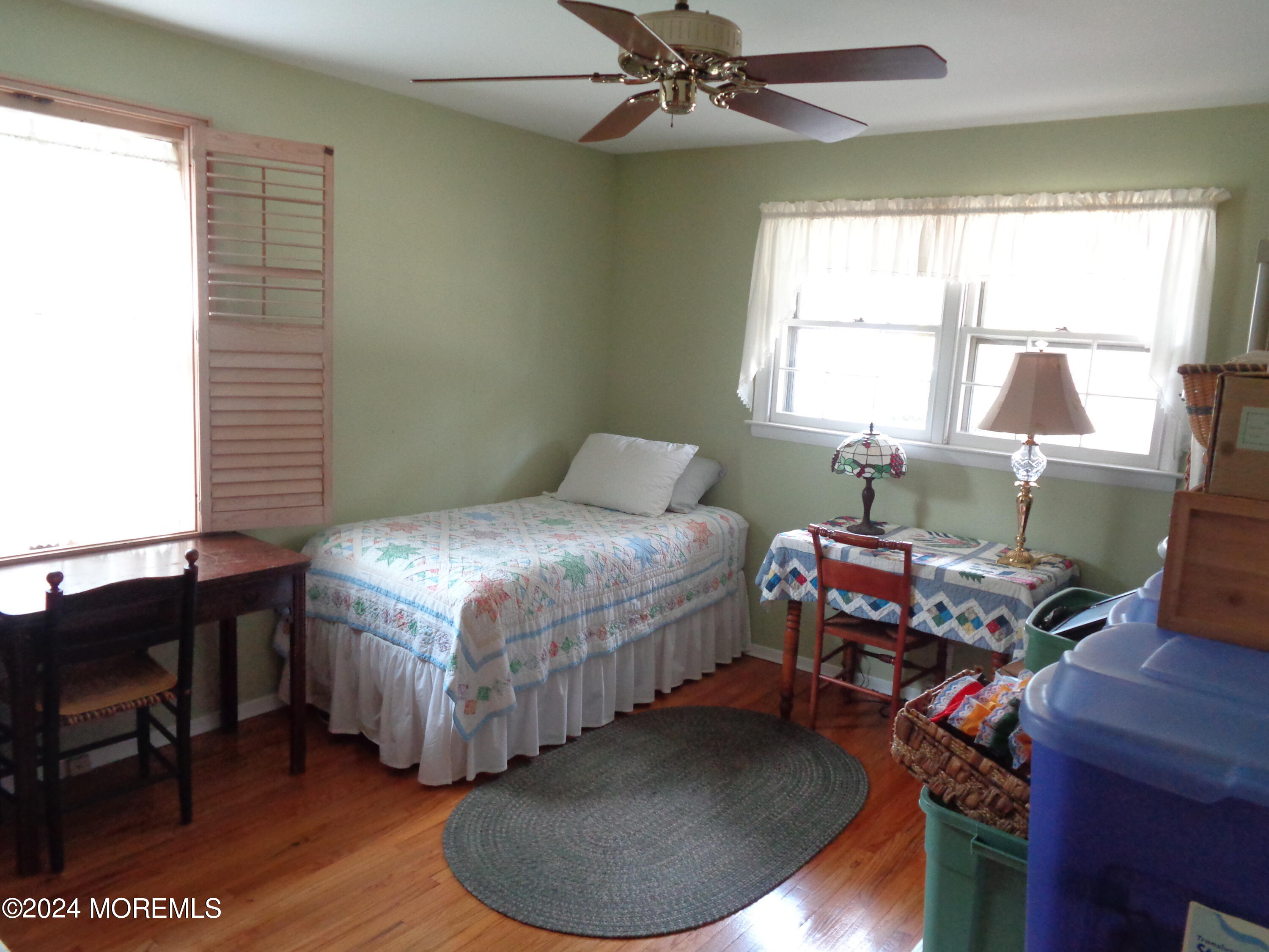 401 Springfield Avenue Pine Beach, NJ 08741 - Photo 14 of 24 a bedroom with a bed and a chandelier